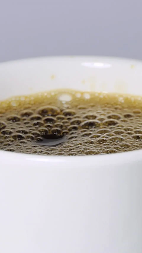 Vertical Screen: Pouring black coffee into a white cup. Top view of coffee Stock Footage 230182797