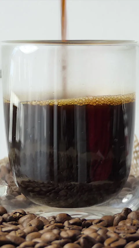 Vertical Screen: Pouring black coffee into a cup. Top view pouring into a cup Stock Footage 231261582