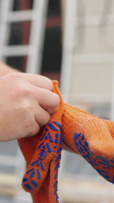 Vertical Screen: POV Worker put on Yellow Gloves on Hands. Point of view Diy Stock Footage 272172265