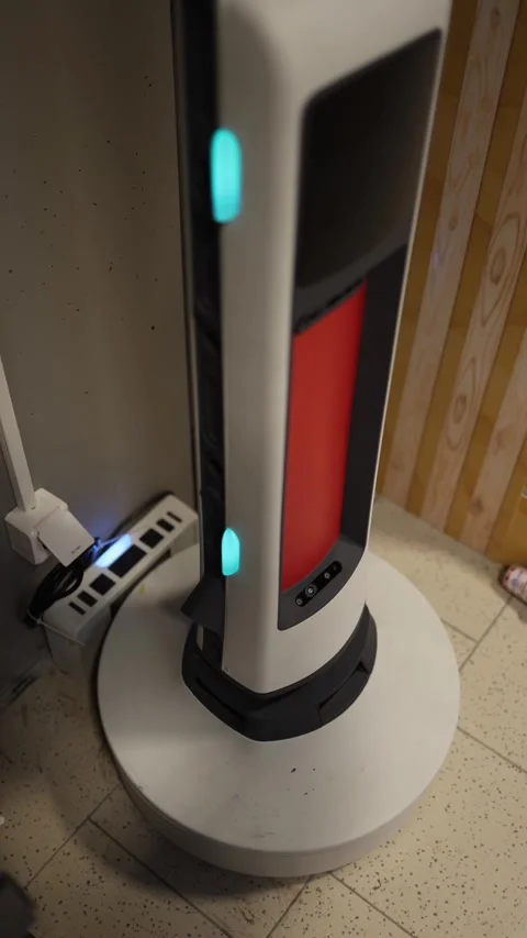 Vertical screen: A price-scanning robot in a supermarket stands near a charging  Stock Footage 303850570