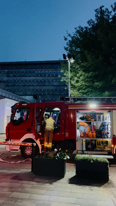 Vertical screen: professional firefighter meticulously preparing emergency Stock Footage 315272208