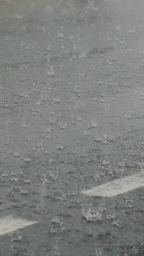 Vertical Screen Rain splashes hit the asphalt during extreme bad weather Stock Footage 299847446
