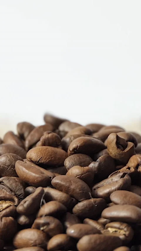 Vertical Screen: Roasted Coffee Beans falling. Fragrant coffee beans are roasted Stock Footage 230304158