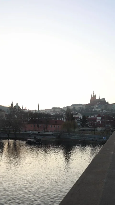 Vertical screen: A scenic view of a historic city at sunset, with a river reflec Stock Footage 303907603