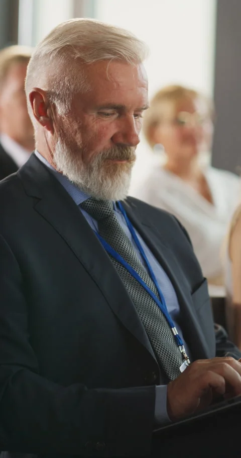 Vertical Screen Senior Man Using Laptop At Conference Stock Footage 255844264