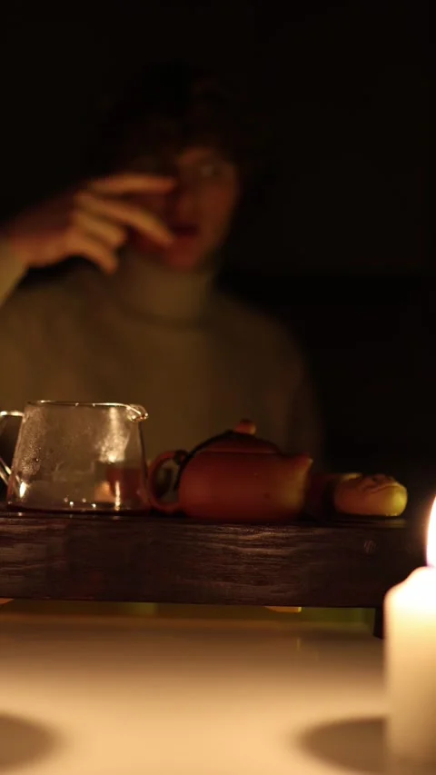 Vertical screen: A serene tea ceremony moment with a person in the background, g Stock Footage 299376648