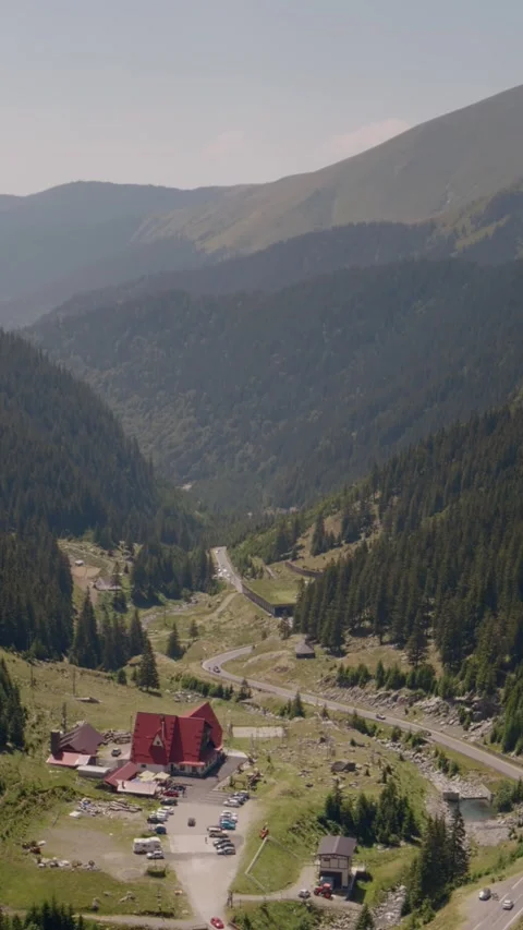 Vertical Screen Serpentine shot in the mountains with settlements at the bottom Stock Footage 299989053