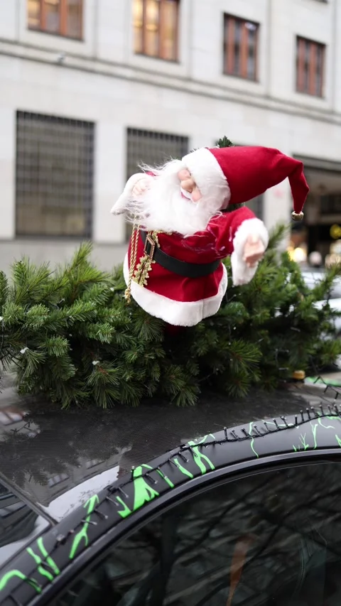 Vertical screen showing a close-up of a cheerful Santa Claus figurine perched on Stock Footage 297264898