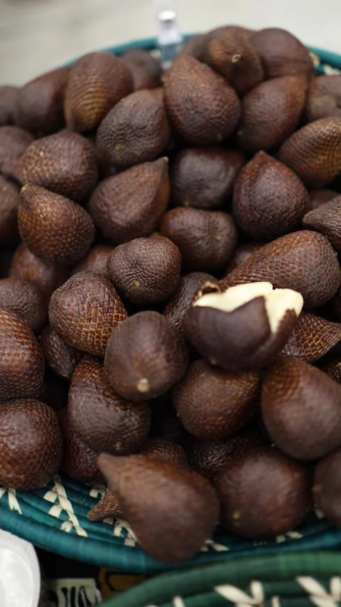 Vertical screen showing a close-up of salak fruits, also known as snake fruit, p Stock Footage 303285939