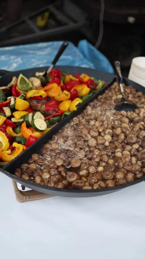 Vertical screen showing a large pan with sautéed vegetables, including bell pepp Stock Footage 303285869