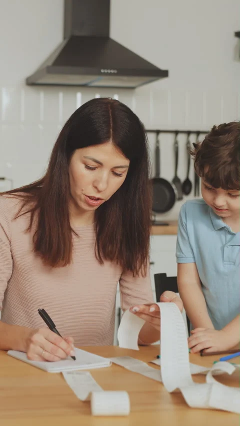 Vertical screen: Single Mother Balancing Budget and Childcare Stock Footage 274521405