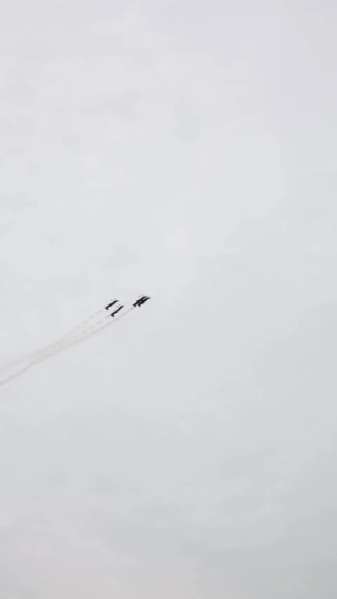 Vertical screen sleek modern jets fly in perfect diagonal formation across soft  Stock Footage 311150066