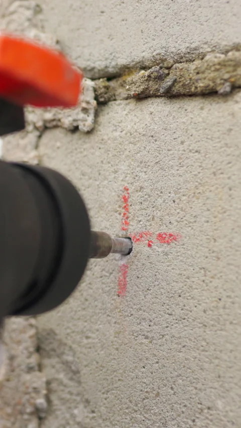 Vertical Screen: SLOW MOTION,: Builder working uses an electric drill to mount a Stock Footage 272174279
