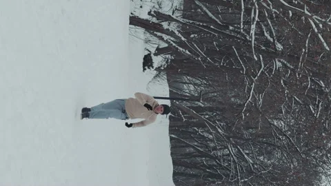 Vertical Screen: Slow motion man running up the hill in winter forest Stock Footage 247047078