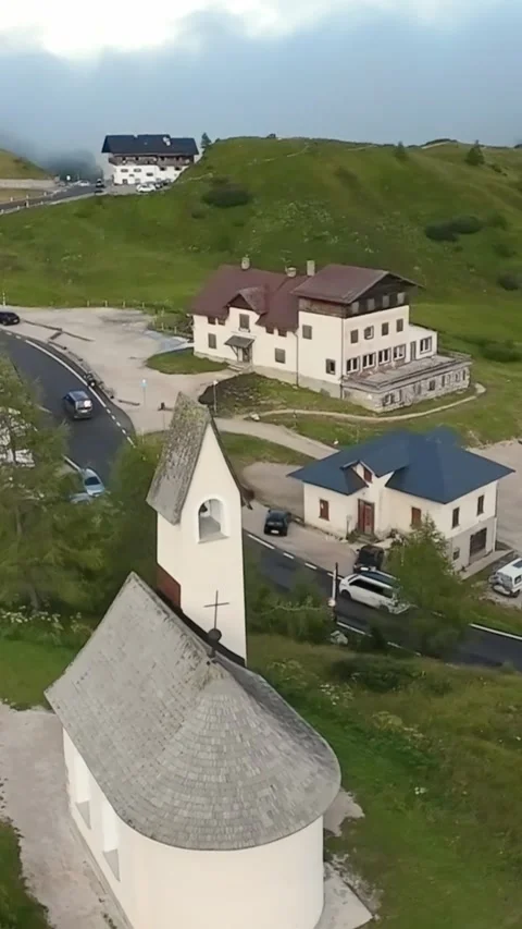 Vertical screen small chapel beside mountain roadside parking quiet alpine lodge 스톡 동영상 323242721