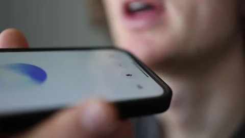 Vertical screen smart voice assistant moment with ChatGPT as user speaks low and Stock Footage 305999360