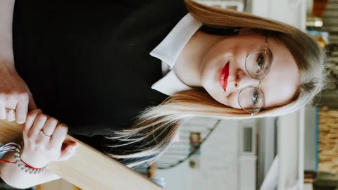 Vertical screen: Smiling waitress girl in empty restaurant when it's closed Stock-Footage 176362015