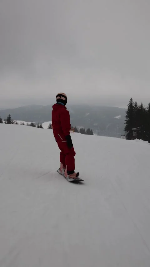 Vertical screen snowboarder calmly riding downhill Stock Footage 327092299