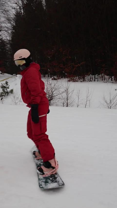 Vertical screen snowboarder turns and falls on slope Stock Footage 327092292