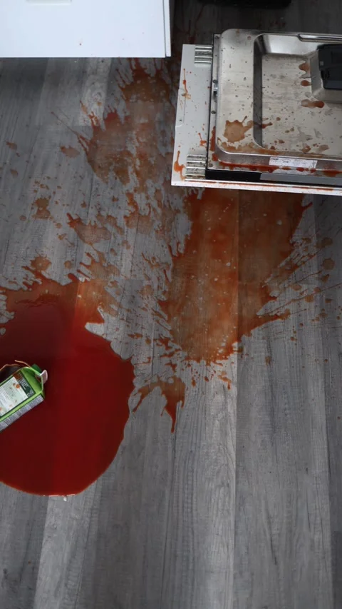 Vertical screen: Spilled red juice on kitchen floor with splashes around an over Stock Footage 304883825