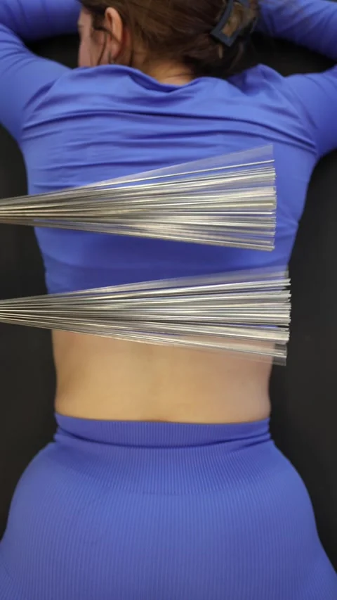 Vertical screen steel brush massage on back in activewear relaxing therapy momen Stock Footage 306596707