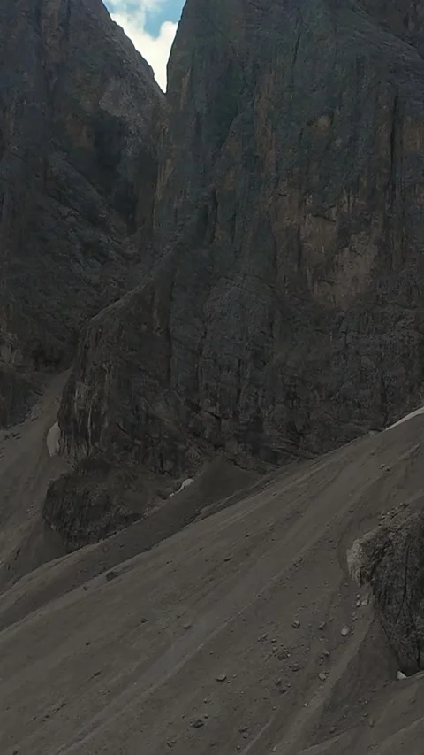 Vertical Screen Steep Scree Slope Beneath Sheer Cliff, Stark Talus Field And Stock Footage 325825569