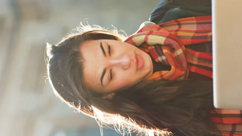 Vertical Screen: Student having zoom event on laptop in park Stock Footage 221889382