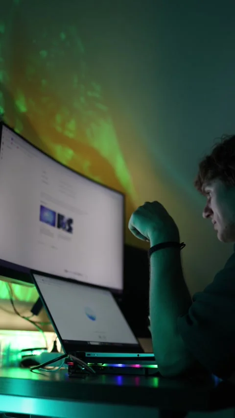 Vertical screen student sits at desk resting chin on hand looking at glowing lap Stock Footage 316702396