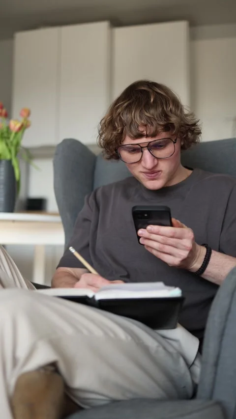 Vertical screen: The student is using his phone with the help of artificial inte Stock Footage 302633054