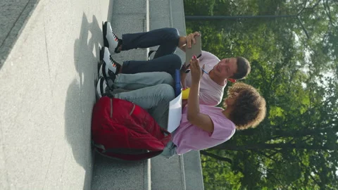 Vertical Screen: Students sitting on stairs after classes Stock Footage 247574836