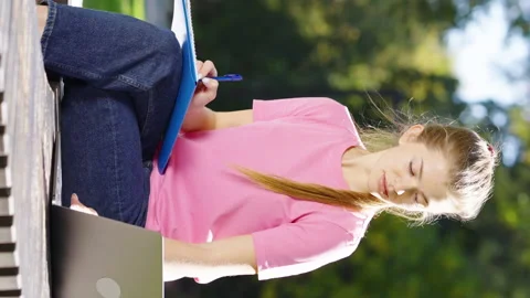 Vertical Screen: Students studying with laptop in park Stock Footage 166682792