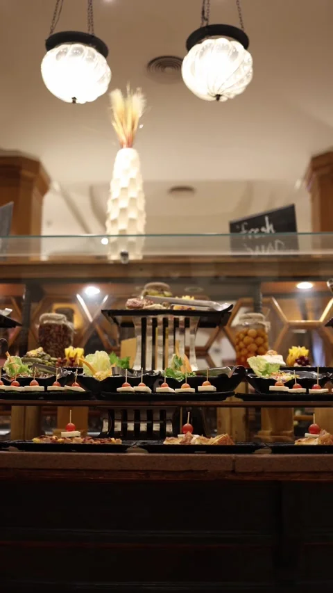 Vertical screen Stylish buffet with gourmet appetizers on black trays garnished  Stock Footage 310017355