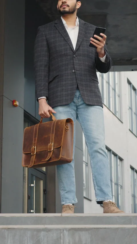 Vertical Screen: Successful arab businessman standing on stairs outdoors and Stock Footage 272837312
