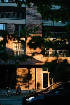 Vertical screen: sunlight illuminating brick facade of modern residential Stock-Fotos