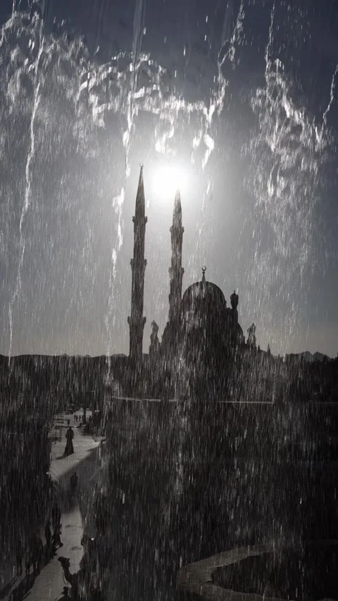 Vertical screen sunlight pierces through cascading fountain in front of mosque s Stock Footage 310019124