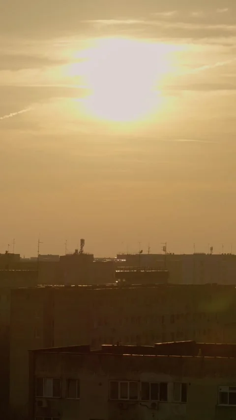 Vertical Screen Sunset over an urban landscape showcasing rooftop buildings Stock Footage 303505370