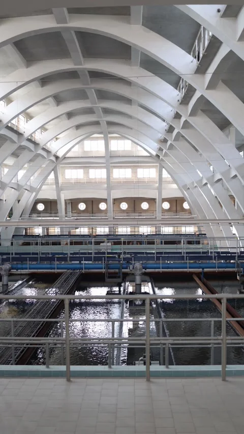 Vertical screen: Symmetrical hall of a water facility bathed in daylight, with a Stock Footage 304883953