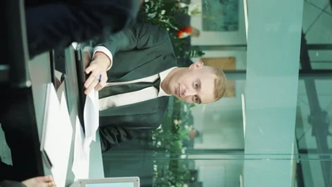 Vertical screen: Team of managers discussing project at meeting Stock Footage 251825604