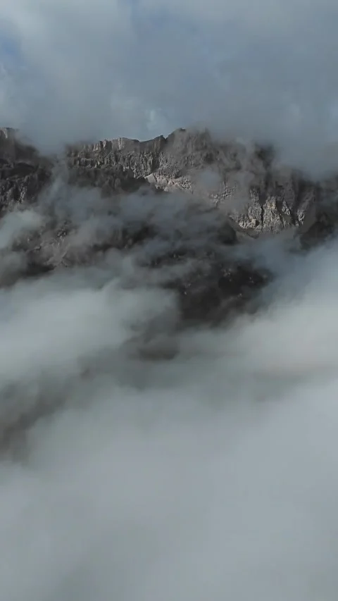 Vertical screen thick cloud shroud covering jagged summits, meteorologist Stock Footage 323242490