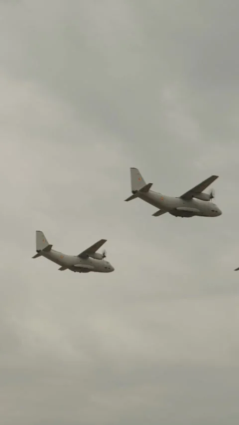 Vertical Screen Three C-27J Spartan aircraft that synchronize perfectly and fly Stock Footage 303507316