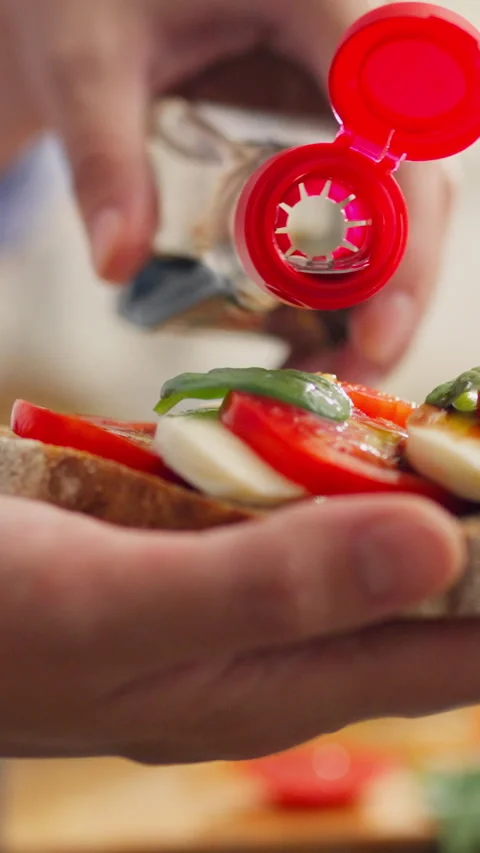 Vertical screen. Toast with sauce. The white woman adds soy sauce. Young par Video stock 331737952