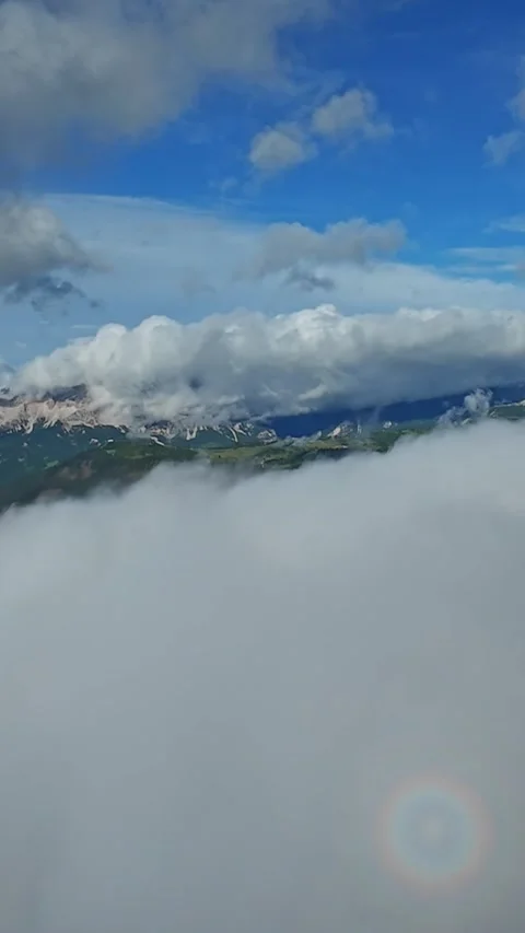 Vertical screen towering cliff above cloud deck with circular glory halo on mist Stock Footage 323242510