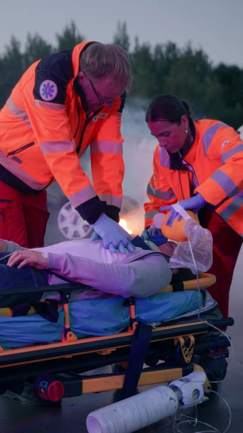 Vertical Screen Traffic Accident and Ambulance Team with Patient Stock Footage 295800788