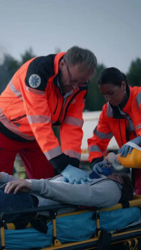 Vertical Screen Traffic Accident and Ambulance Team with Patient Stock Footage 295801137