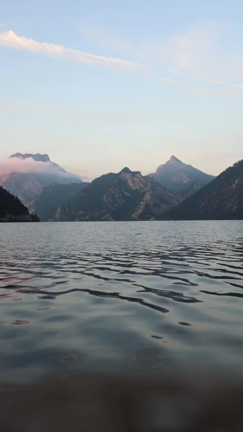 Vertical screen tranquil lake reflecting soft evening light surrounded by alpine Stock Footage 318778650