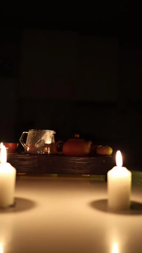 Vertical screen: A tranquil tea setup surrounded by the soft glow of candles. A  Stock Footage 299371823