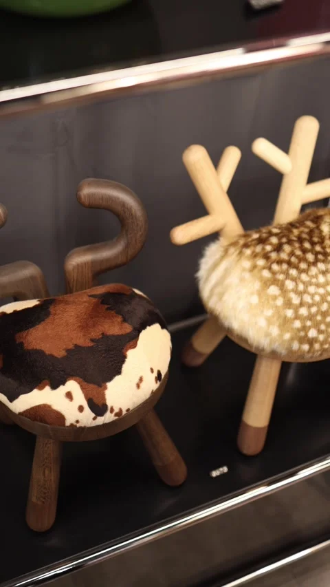 Vertical screen two creative stools with fur seats and wooden legs designed like Stock Footage 318869425