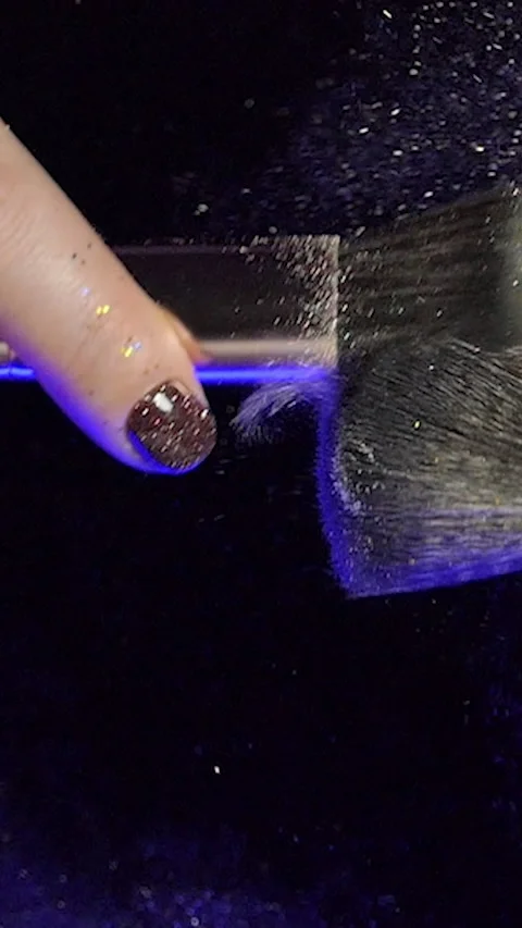 Vertical Screen: two makeup brushes with powder on a dark background Stock Footage 229966344