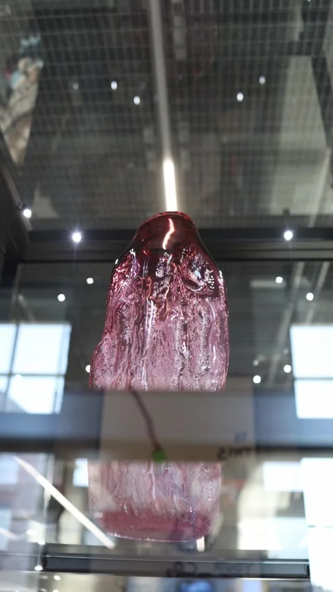 Vertical screen: A unique glass sculpture with a fluid, organic form displayed i Stock Footage 304459555