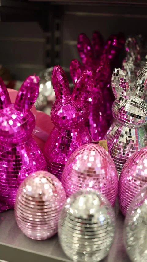 Vertical screen unsold shiny Easter bunnies and eggs covered in bright  Stock Footage 330014771